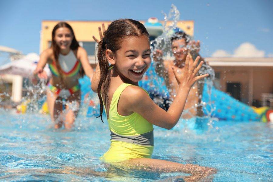 Happy family having fun at water park. Summer vacation